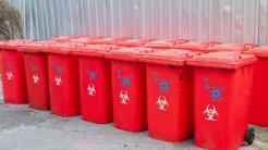 red bins group with symbol infectious in the outdoors keep clean from germs virus. concept prevent garbage infection coronavirus (covid-19)