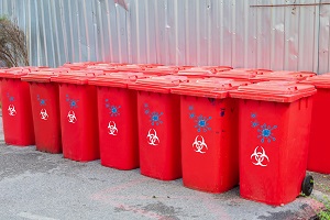 red bins group with symbol infectious in the outdoors keep clean from germs virus. concept prevent garbage infection coronavirus (covid-19)