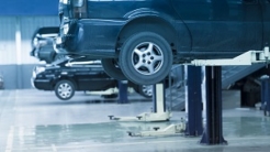 Cars up on lifts in an auto repair shop