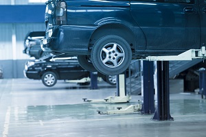 Cars up on lifts in an auto repair shop