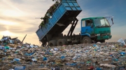 dump truck unloading the waste on a open dumping site