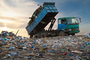 dump truck unloading the waste on a open dumping site