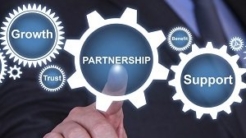 Person pointing to the word partnership within an icon of a cog