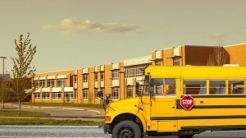 Yellow school bus outside of school