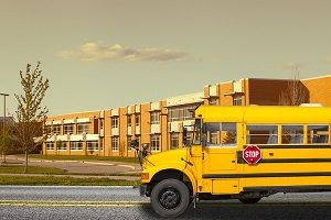 Yellow school bus outside of school