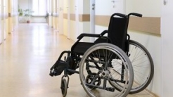 Wheelchair sitting in hallway of medical facility