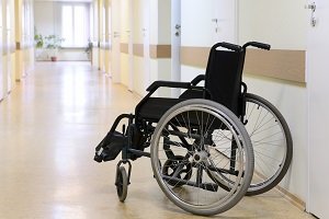 Wheelchair sitting in hallway of medical facility