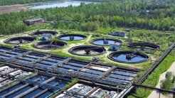 Wastewater treatment plant with green trees around