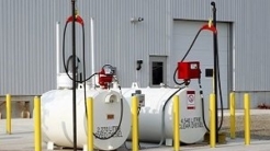 Two storage tanks with yellow barricades