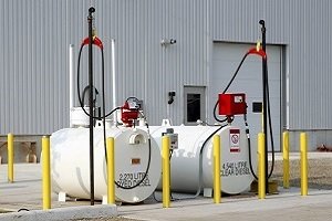 Two storage tanks with yellow barricades