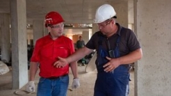 Photo by Aleksey from Pexels Two men in hard hats on building site