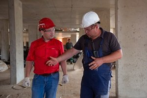 Photo by Aleksey from Pexels Two men in hard hats on building site