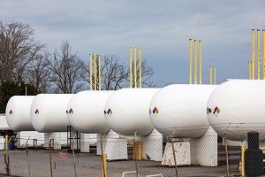 Several large white storage tanks lined up