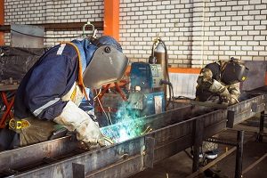 Welder wearing hat and gloves