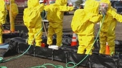 Hazmat workers rinsing water