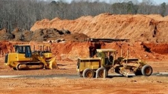 Construction vehicles with dirt piles