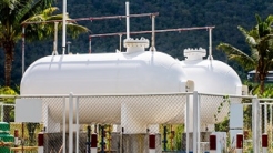 White storage Natural Gas Tank on day noon light for small factor.