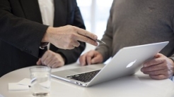 Business meeting with two people and laptop