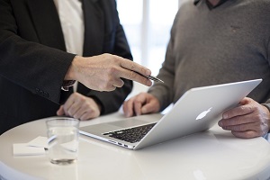 Business meeting with two people and laptop