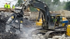 Demolition machinery crushing rocks and metal