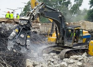 Demolition machinery crushing rocks and metal