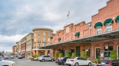 Strip mall with cars in parking lot