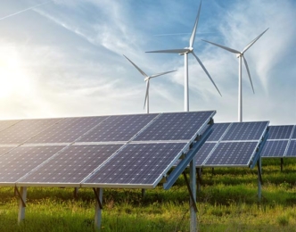 Solar panels with three wind turbines in the distance